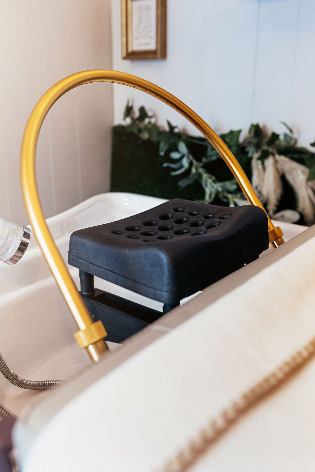 Gold spa shampoo basin with cushioned neck rest and eucalyptus accents in the head spa room at A Shade of Vintage